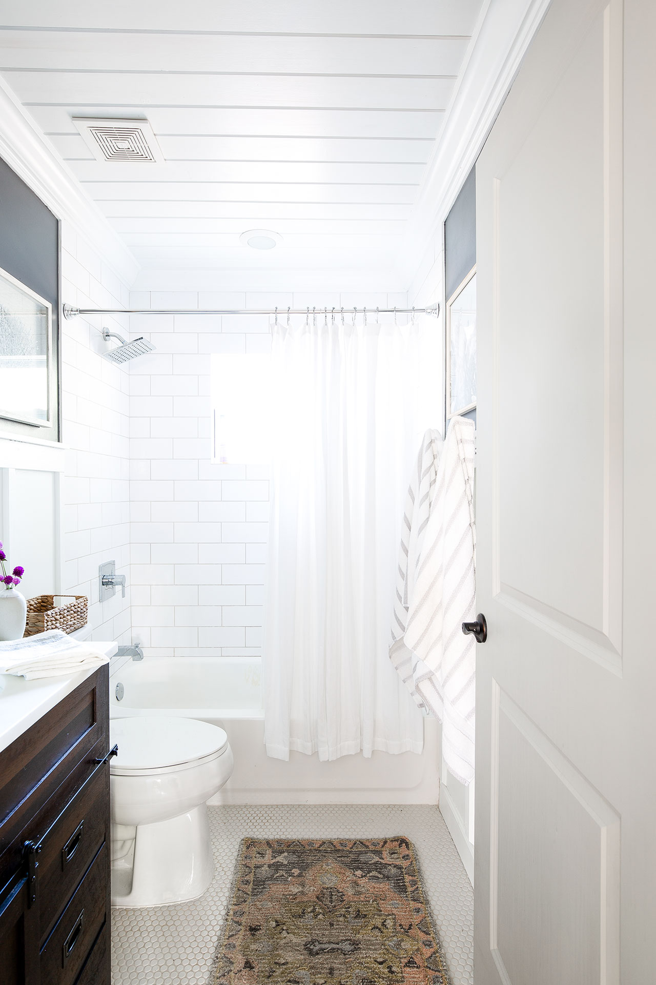 Bathroom Remodel with Natural Light, Beautiful White Tile, with Wall Decor
